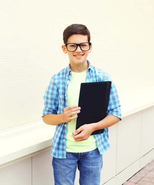 Happy smiling smart teenager boy in glasses with folder or book — Stock Photo, Image