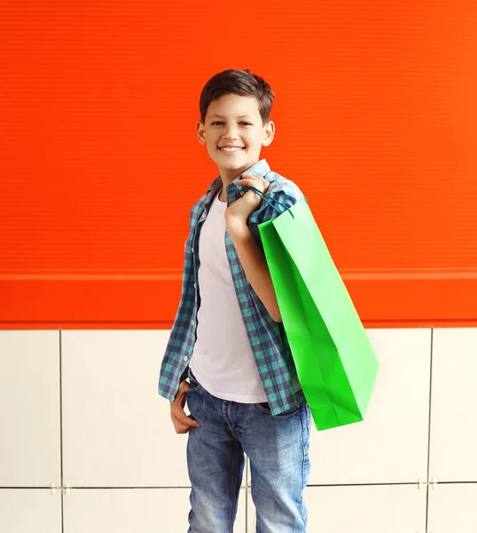 Portrait happy smiling little boy teenager with shopping bag in — Stock Photo, Image
