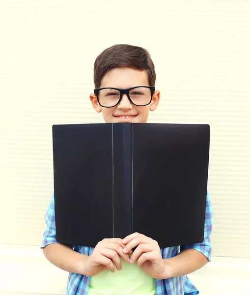 Portrait smiling smart teenager boy in glasses with folder or bo — Stock Photo, Image