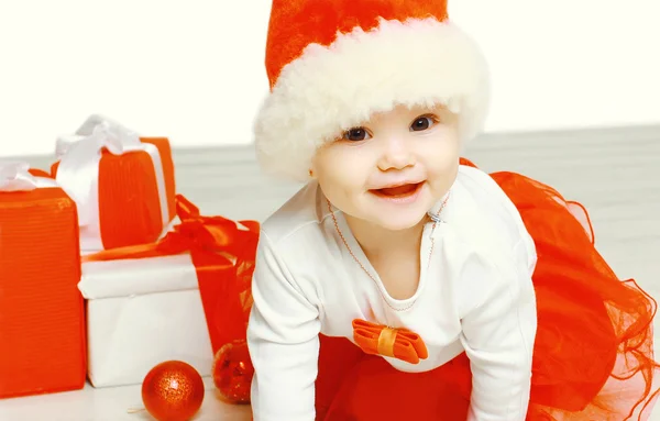 Christmas and people concept - cute smiling child in santa red h — Stock Photo, Image