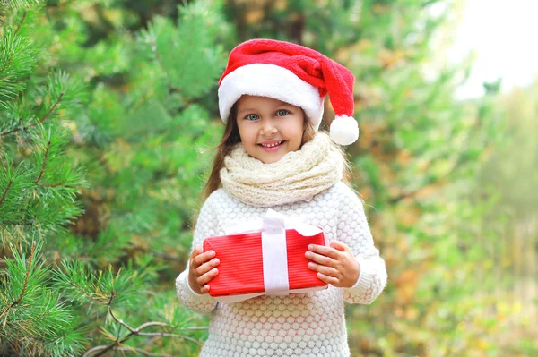 Christmas and people concept - happy smiling child in santa red — Stockfoto