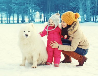 Kış günü, anne ve çocuk ile beyaz yürüyüş mutlu aile