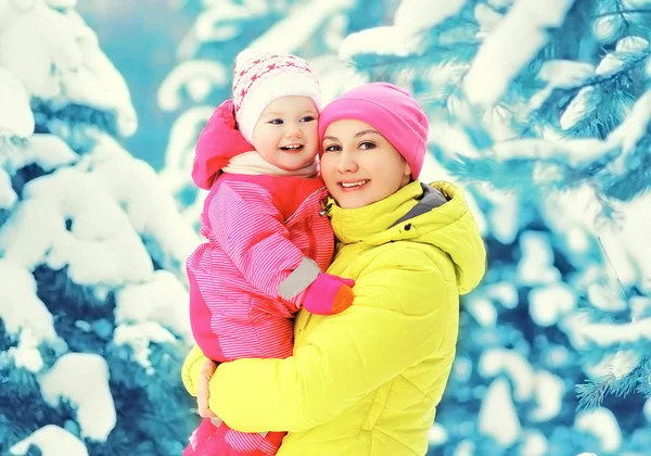 Joyeux sourire mère et enfant s'amuser ensemble dans la neige wint — Photo