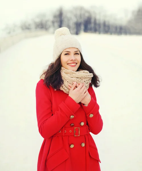 Portrait happy young smiling woman wearing a red coat, knitted h — Stock Photo, Image