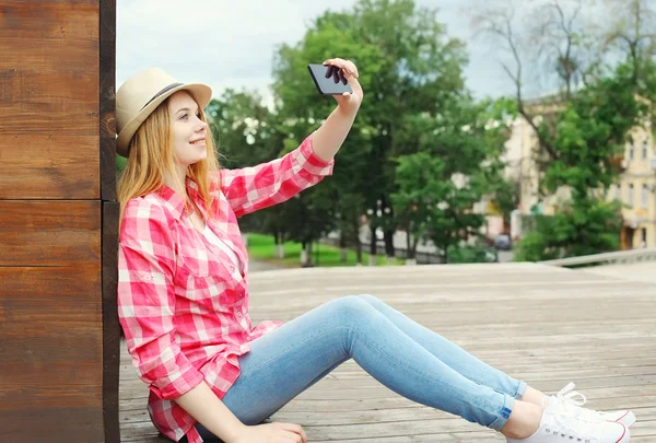 Chica bastante cool tomando foto autorretrato en el teléfono inteligente en c — Foto de Stock