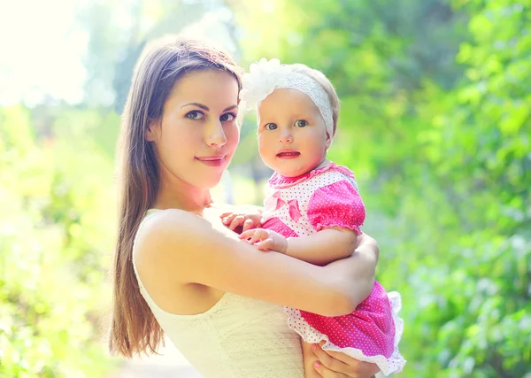 Portrait happy young mother and baby on hands in summer day — Stock Photo, Image