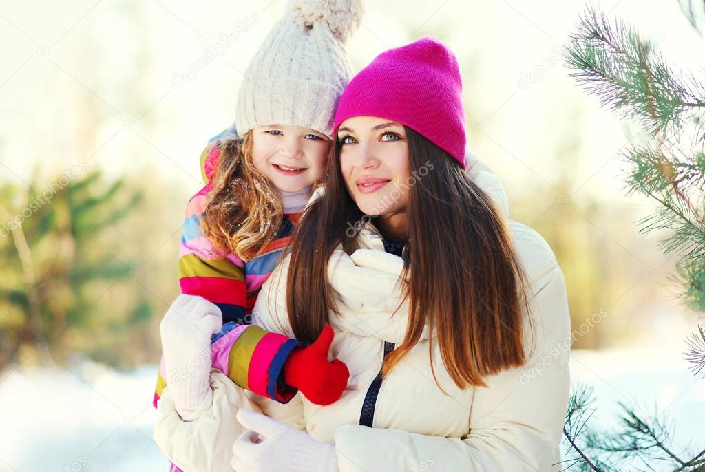 Happy mother and child together in winter day
