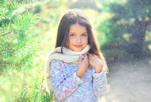 Portrait little girl child wearing a scarf and sweater near chri — Φωτογραφία Αρχείου