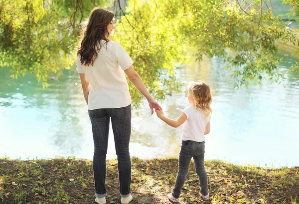 Madre e hija feliz tomados de la mano en verano —  Fotos de Stock