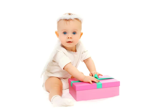 Baby sitting with gift box on a white background — Stock Photo, Image