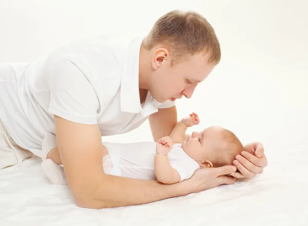 Glücklicher junger Vater mit Baby zu Hause im Bett — Stockfoto