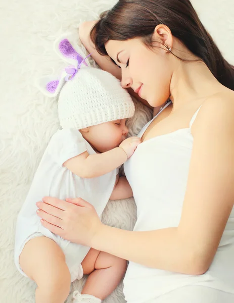 Retrato feliz joven madre durmiendo con el bebé en la cama en casa, t — Foto de Stock