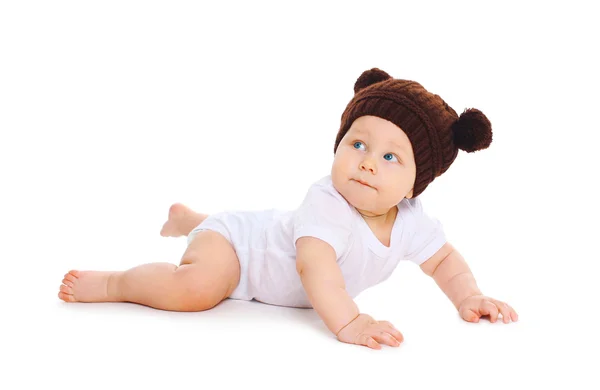 Cute baby in knitted brown hat with ears bears crawls on white b — Stock Photo, Image