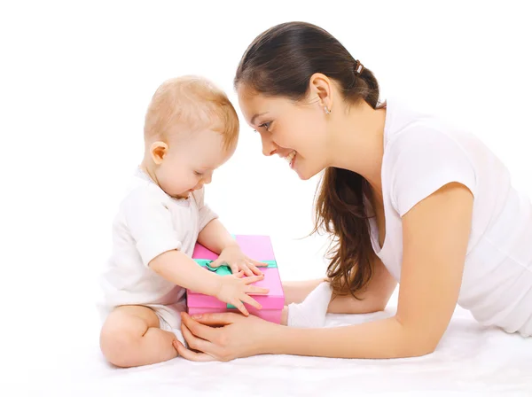 Happy smiling mother and baby with gift box on a white backgroun Royalty Free Stock Images