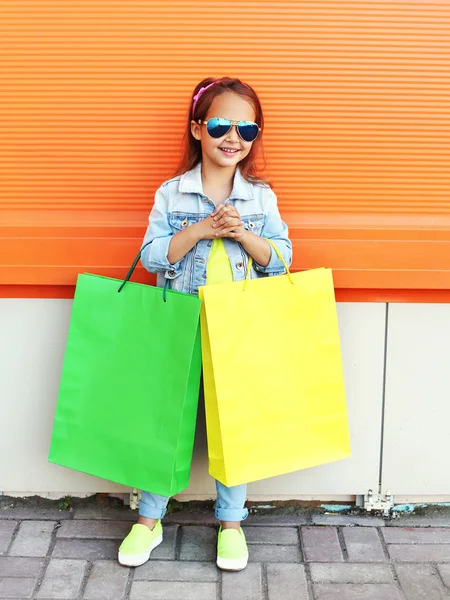 Happy little girl child wearing a sunglasses and jeans clothes w — Stock Photo, Image