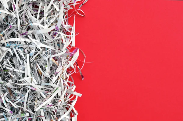 Shredded paper on red background. Selective focus image.