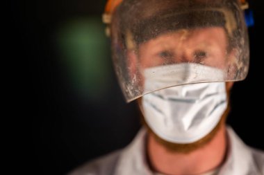 Avustralya 'da laboratuvar önlüğü ve eldiven giyerken maske ve yüz maskesi takan Covid doktor, hemşire ve sağlık görevlisi. Salgın sırasında hastaneye kaldırıldı..