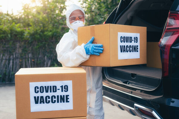 Health Worker Wearing Protective Suit Loading Covid Vaccine Car Cargo Royalty Free Stock Images
