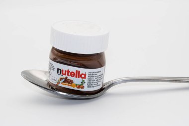 Zurich, Switzerland - November 4, 2020: Nutella is Italian world's famous chocolate cream by Ferrero industry. Mini bowl of nutella on a spoon