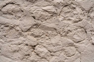 Soyut bir arka plan dokusu için Fransa 'nın Honfleur kentindeki eski bir taş duvarı kapatın..