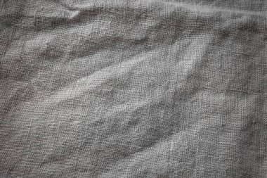 Gri Pamuk Çuval Bezi Kumaş Arkaplan. Kahverengi Hessian Jute Tekstil Peçetesi. Masa yüzeyinde doğal organik keten masa örtüsü.