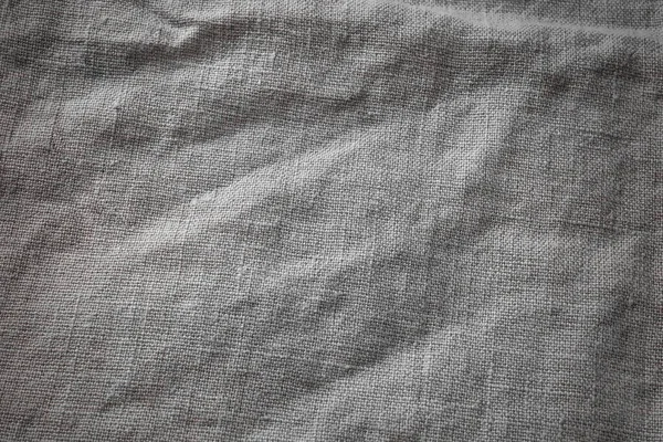 Gri Pamuk Çuval Bezi Kumaş Arkaplan. Kahverengi Hessian Jute Tekstil Peçetesi. Masa yüzeyinde doğal organik keten masa örtüsü.