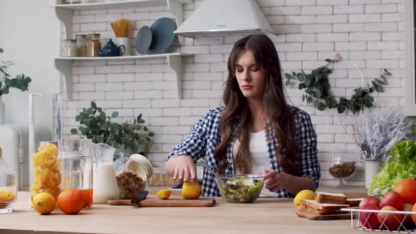 Gezonde vrouw knijpt citroen in veganistische salade. Vrouwelijke chef knijp citroen — Stockvideo