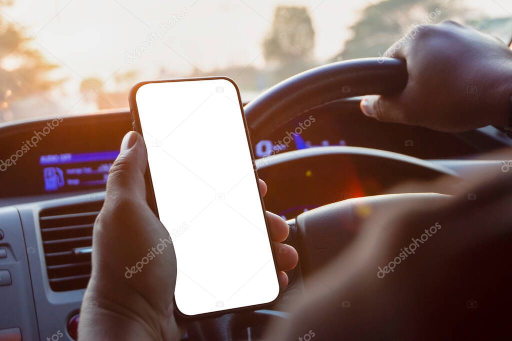A blank white smartphone screen in the hand of a man in a car