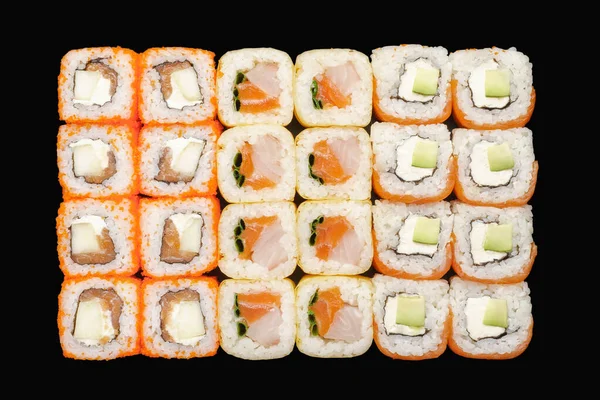 Sushi roll set with salmon, Philadelphia cheese, avocado, masago caviar, apple, perch, tobiko caviar, green onion, soy paper, unagi sauce. Isolated on black background