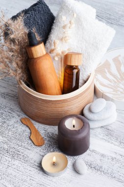 Ahşap arka planda yeniden kullanılabilir şişelerdeki temel yağ. Çevre dostu ambalajlı doğal organik spa