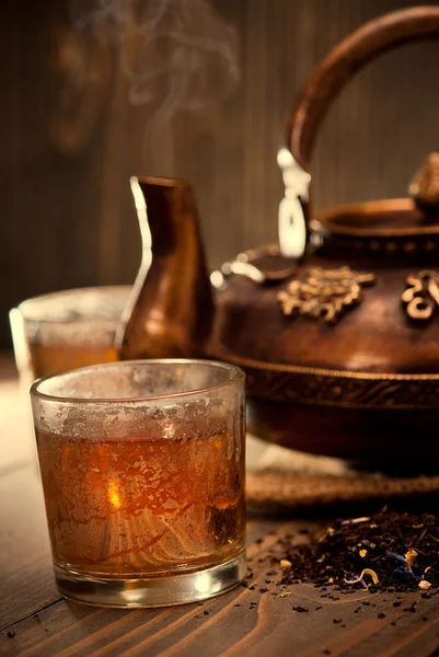 Tetera caliente de hierro antiguo sobre fondo de madera oscura — Foto de Stock