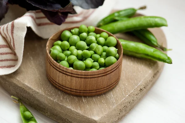 Primer plano de guisantes verdes sobre fondo de madera —  Fotos de Stock