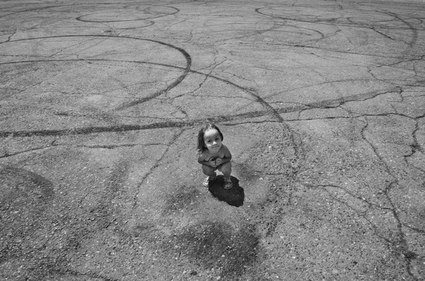 Girl on an asphalt road with skid marks — Stock Photo, Image