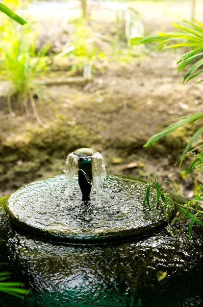 Water fall down into the  Large Jar Royalty Free Stock Photos