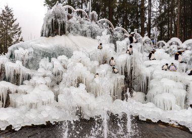 Buz kristalleri. Penguen oyuncaklı buz saçakları. Fribourg, İsviçre.