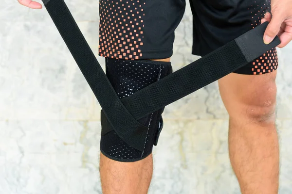 The man wear Knee Support with sunlight in the park / Brace Knee Pads Leg