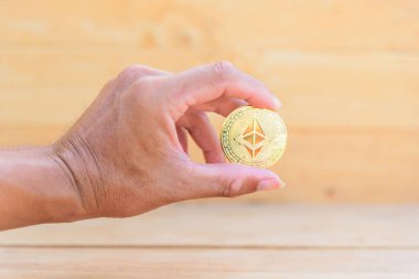 The man show Golden Bitcoin cryptocurrency in his hand