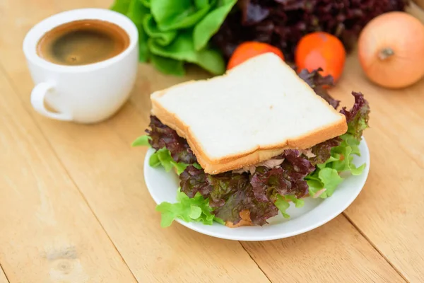 朝食にホットコーヒーと白皿のサンドイッチマグロ — ストック写真