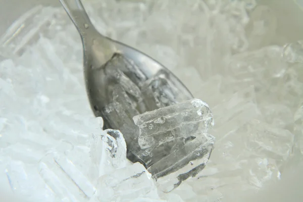 Ice in a spoon — Stock Photo, Image