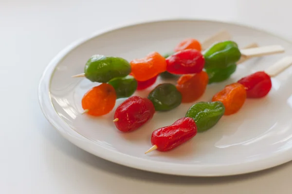 Mix of dried fruits on wooden skewers Stock Image