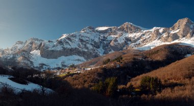 Colio, Cillorigo de Liebana, Cantabria 'nın panoramik manzarası. Etrafında karlı dağlar