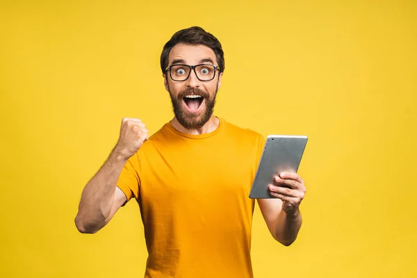 Happy Young Bearded Man Casual Standing Using Tablet Computer Isolated Royalty Free Stock Images