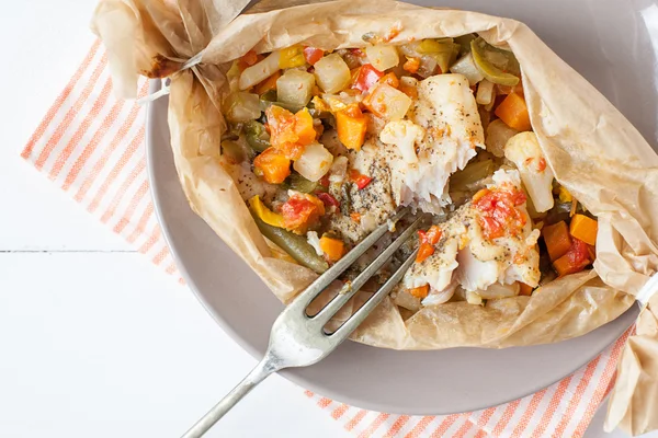 Peixe frito com legumes em pergaminho — Fotografia de Stock