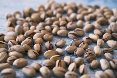 Close-up of Salted and dried Pistachios on the Blurred painted stone table as background. Concept of healthy nutrition. Selective focus. Copy space.
