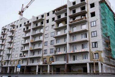 Kazan, Tataristan, Rusya - Eylül 2021: bulutlu gökyüzüne karşı inşaat halinde olan tipik bir gökdelen. Noviye Gorki adında bir yerleşim yeri. Kazan şehrinde Gran Gelişimi