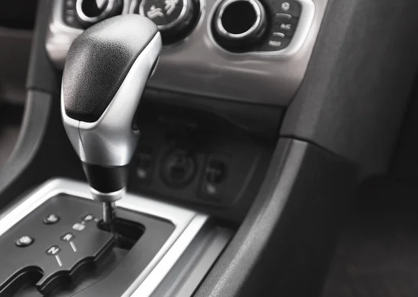 Detail of an automatic gear shifter in a new, modern car. Modern car interior.