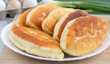 Yumurta ve yeşil soğanla kızartılmış Rus küçük turtaları.