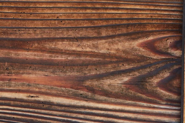 Old grunge aged wood background. The surface of weathered brown wood texture.