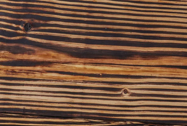 Old grunge aged wood background. The surface of weathered brown wood texture.