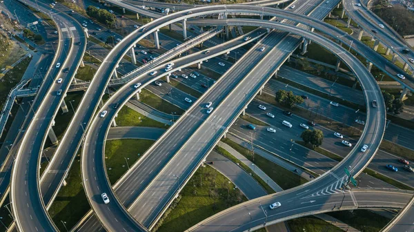 Top up aerial drone view of elevated road and traffic junctions in Chinese metropolis city Chengdu during sunny day. Modern construction design of traffic ways to avoid traffic jams. Few vehicles, no traffic jam on the road